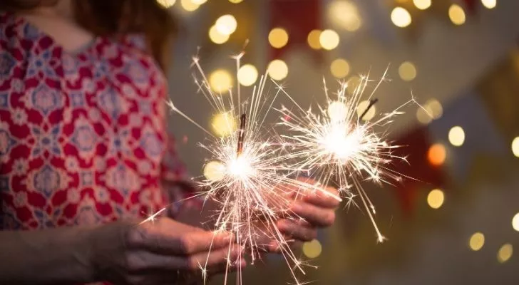 A woman holding two sparklers