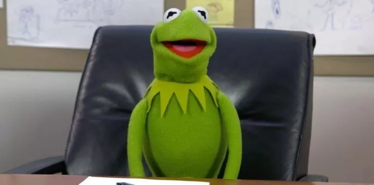 Kermit sat on a leather sofa