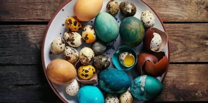 A bowl of many colourful eggs