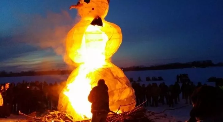 a huge tall snowman about to burn