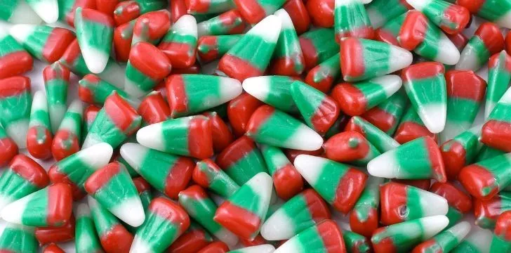 Candy corn with a red lined bottom, green lined centre and a white tip.