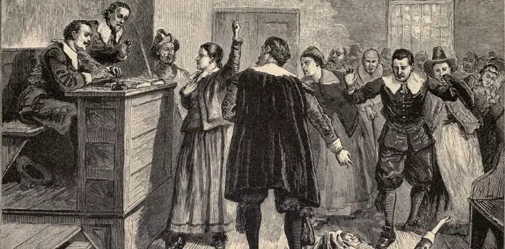 An illustration of a witch being trialed in court.