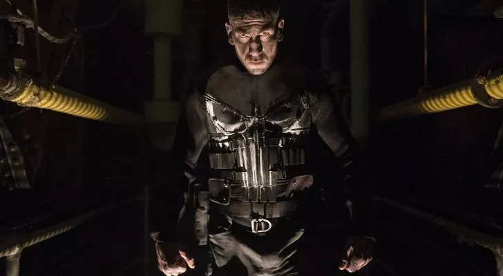 Picture of The Punisher in a dark room.