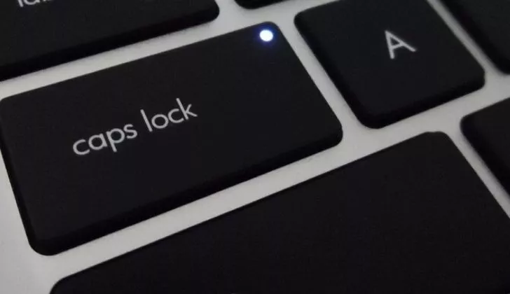 A picture zoomed into the caps lock key on a keyboard.