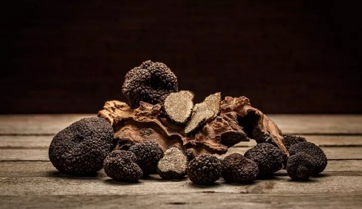 Several truffles on a wooden table