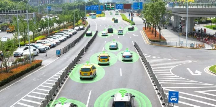A picture of cars on a highway with green circles around them as a representation of them being driverless cars