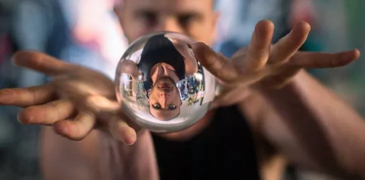 A man with a contact juggling ball between his hands.