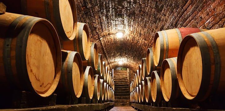Wine is aged in oak barrels.