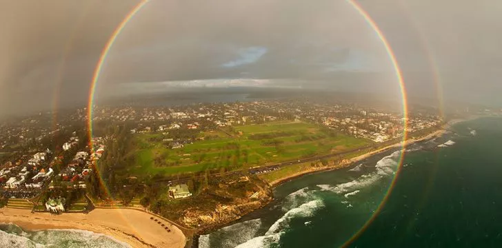 A round rainbow photo taken from a plane