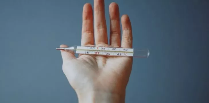 Someone holding a thermometer