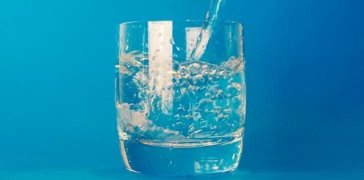 Water being poured into a small glass