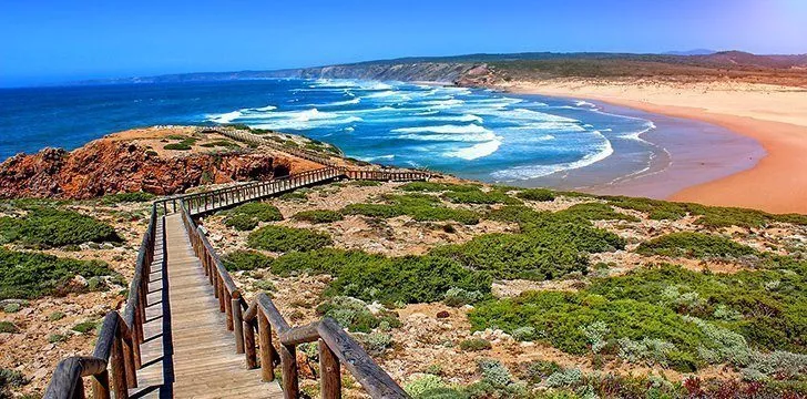 A wooden walkway leading down to one of the Algarve's beautiful sandy beaches