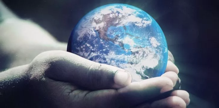 Earth being held in human hands