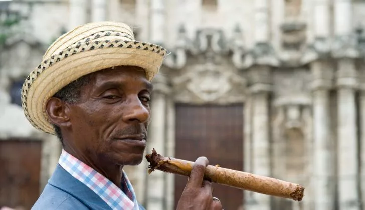 A man smoking a Cuban cigar.