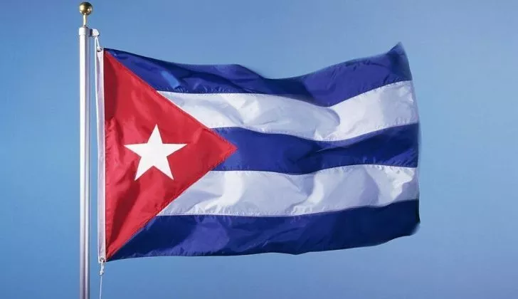 The Cuban flag flying on a pole.