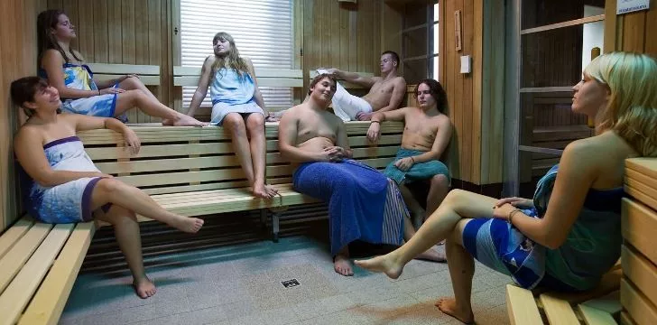 A hungover group of people sweating it out in the sauna