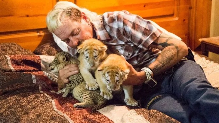 Joe Exotic cuddling with tiger cubs