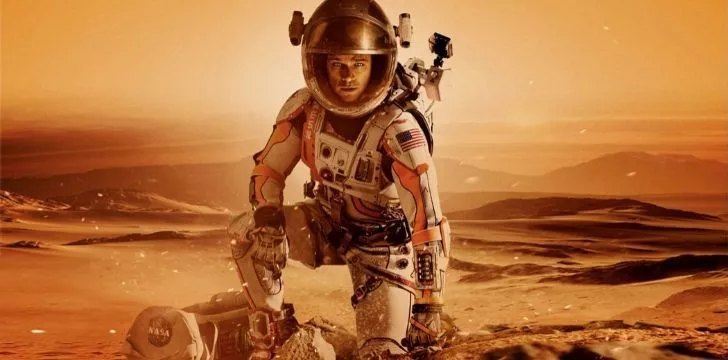 Matt Damon standing on the surface of Mars in the movie The Martian