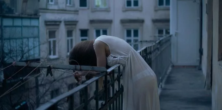 A depressed women on a balcony