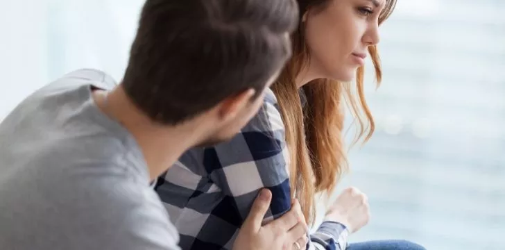 A man comforting a woman