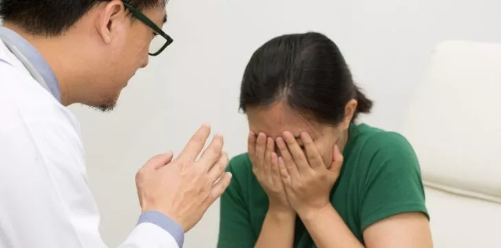 A woman crying into her hands