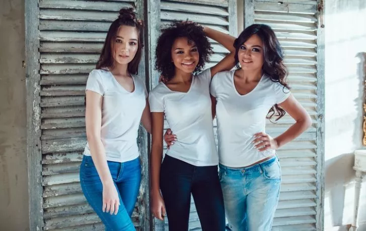 Three young women wearing white t-shirts
