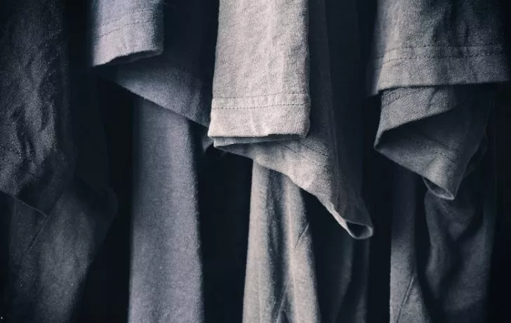 Three different gray t-shirts on a rail