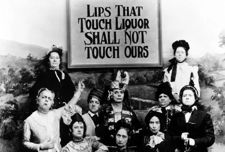Women standing up against people drinking alcohol