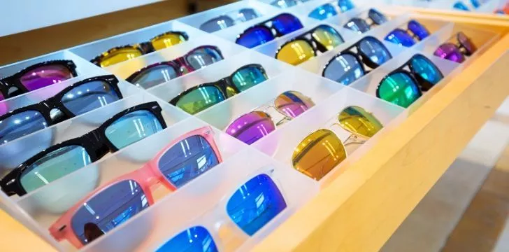 A tray of sunglasses in many colors