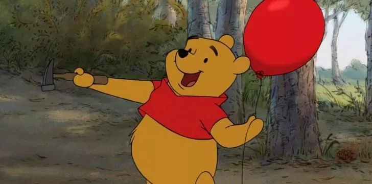 Winnie the Pooh holding a balloon