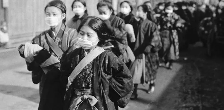 A line of asian women wearing face masks