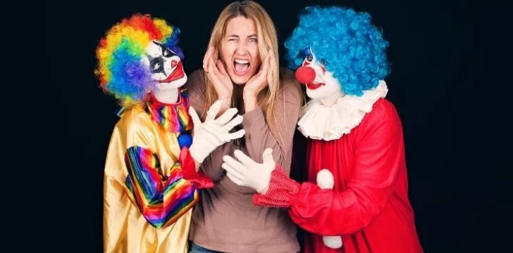 A picture of a woman terrified of clowns