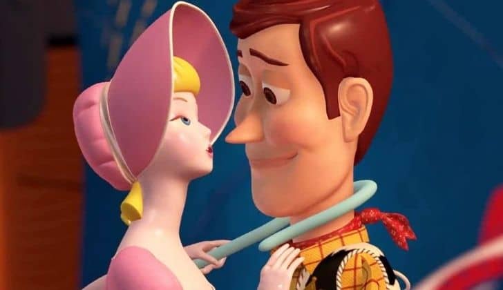 Woody with rosey cheeks as Bo Peep pulls him in closer to her with her stick