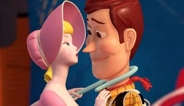 Woody with rosey cheeks as Bo Peep pulls him in closer to her with her stick