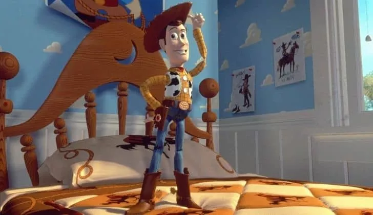 Wood standing tall and tapping his cowboy hat with his finger.