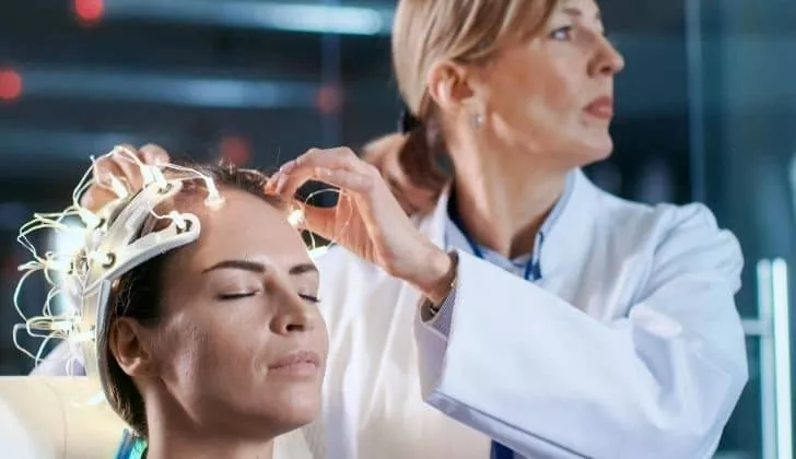 A doctor carrying out an experiment on a patients brain