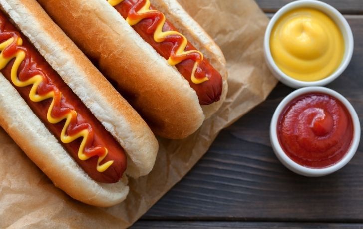 Two beautiful hot dogs with mustard and good ole ketchup