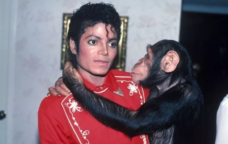 Michael Jackson with holding his pet chimp