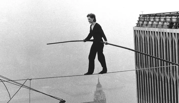Philippe Petit walking wire between the Twin Towers