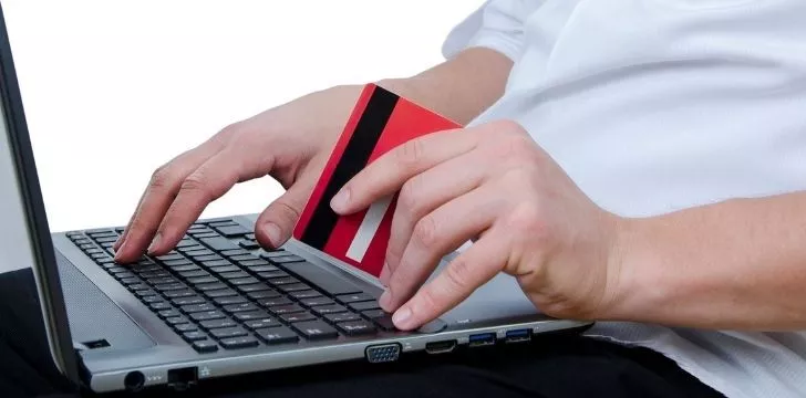 A man holding a credit card