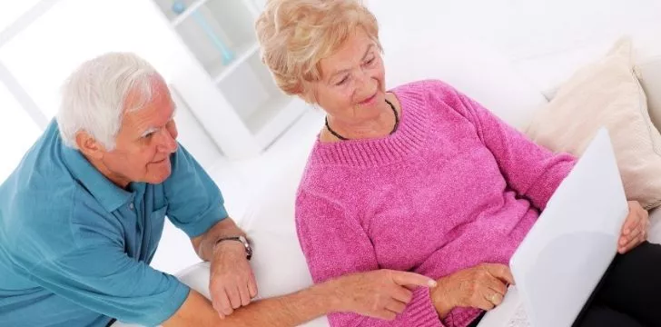 An older couple using a laptop