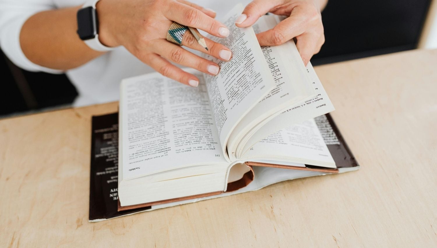 Woman flicking through a dictionary