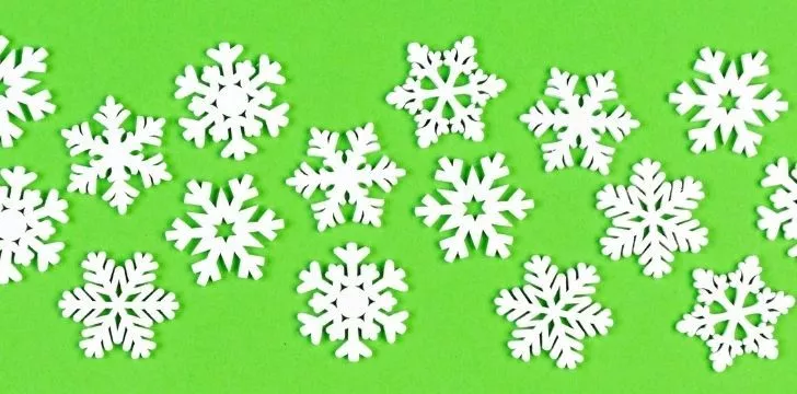 White snowflakes on a green background