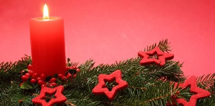Red candle on a Christmas tree branch