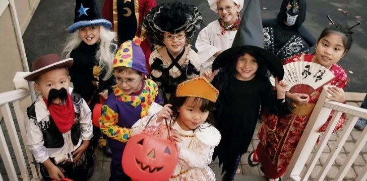 Children trick or treating expecting to be given candy