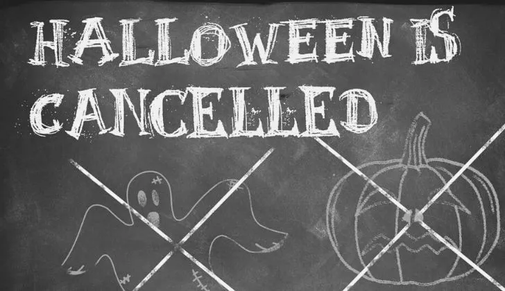 "Halloween is cancelled" written on a chalk board