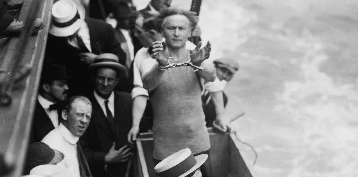 Harry Houdini handcuffed on a boat