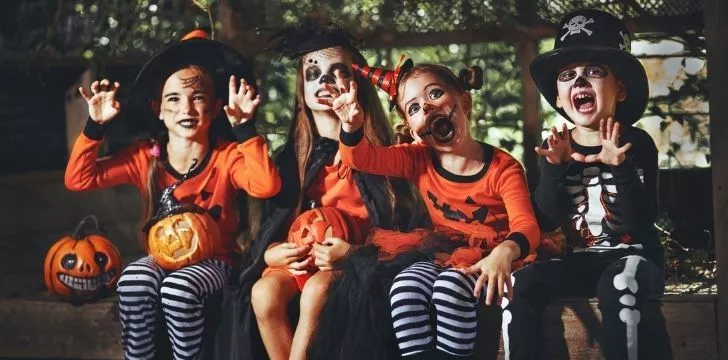 Children sitting in Halloween costumes