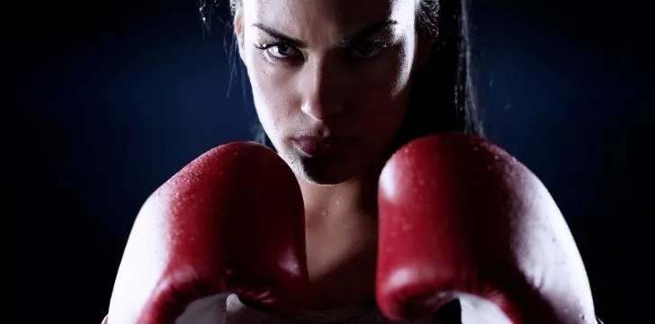 A female fighter in boxing gloves
