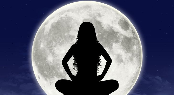 Silhouette of a woman infant of a big full moon